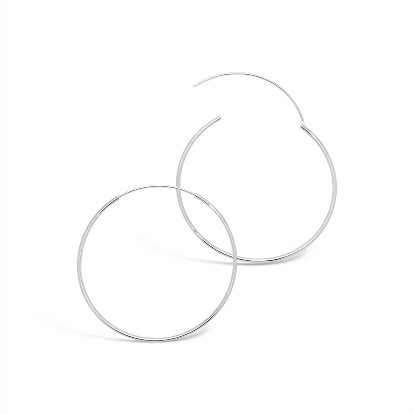 Detailed view of overlapping 50mm 925 sterling silver fine hoop earrings showing the open clasp closure on a white background