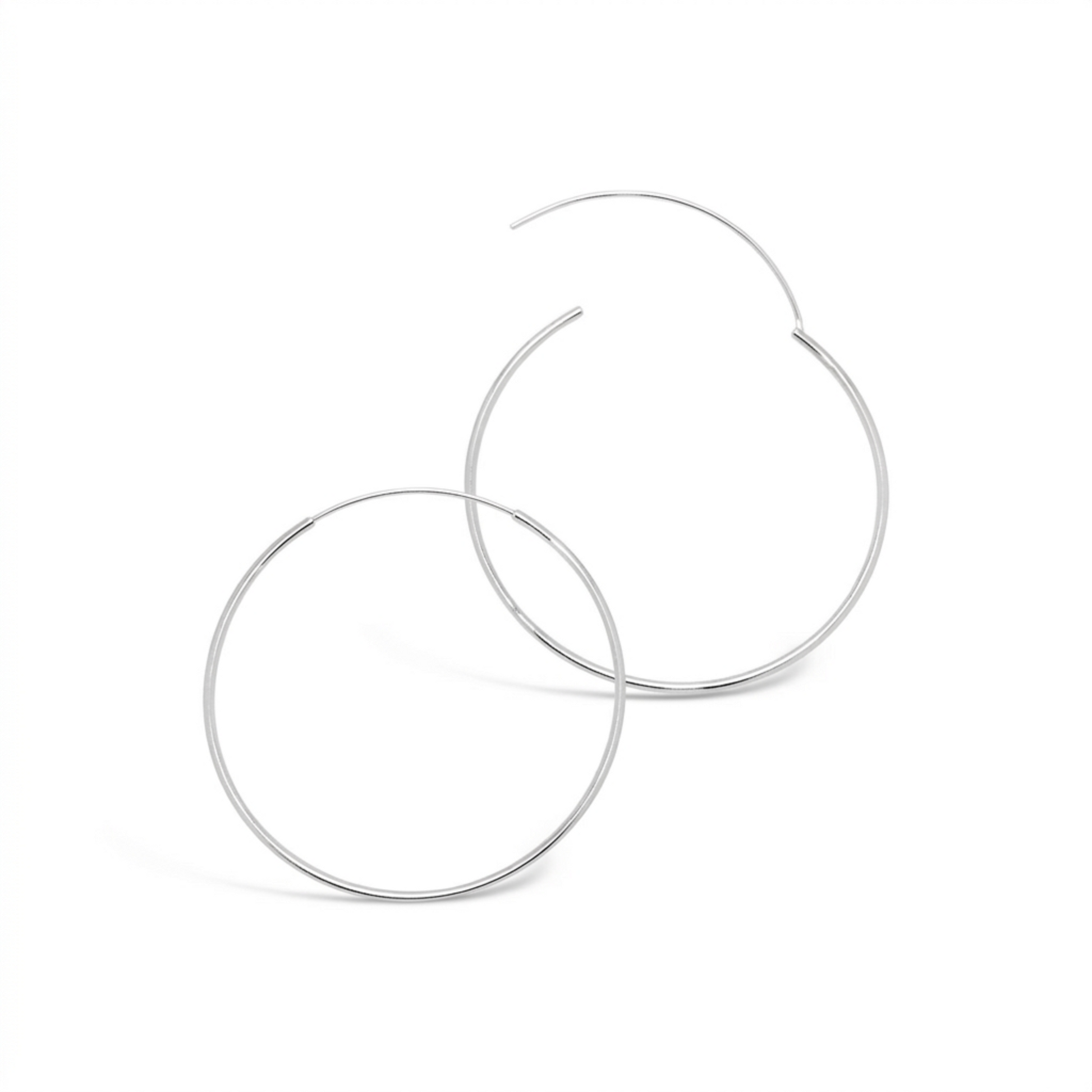 Detailed view of overlapping 50mm 925 sterling silver fine hoop earrings showing the open clasp closure on a white background