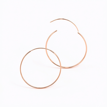 Detailed view of overlapping 50mm 925 sterling silver rose gold fine hoop earrings showing the open clasp closure on a white background 